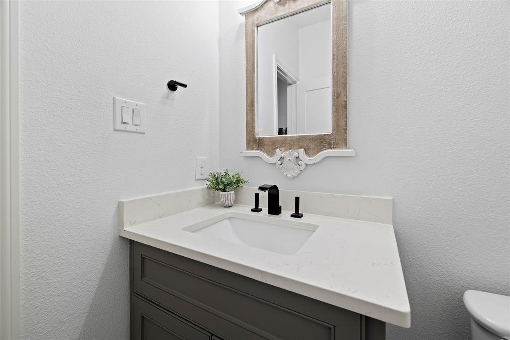203 Colonial Drive Mabank, TX 75156 - Photo 26 of 36 a bathroom with a sink a vanity and a mirror