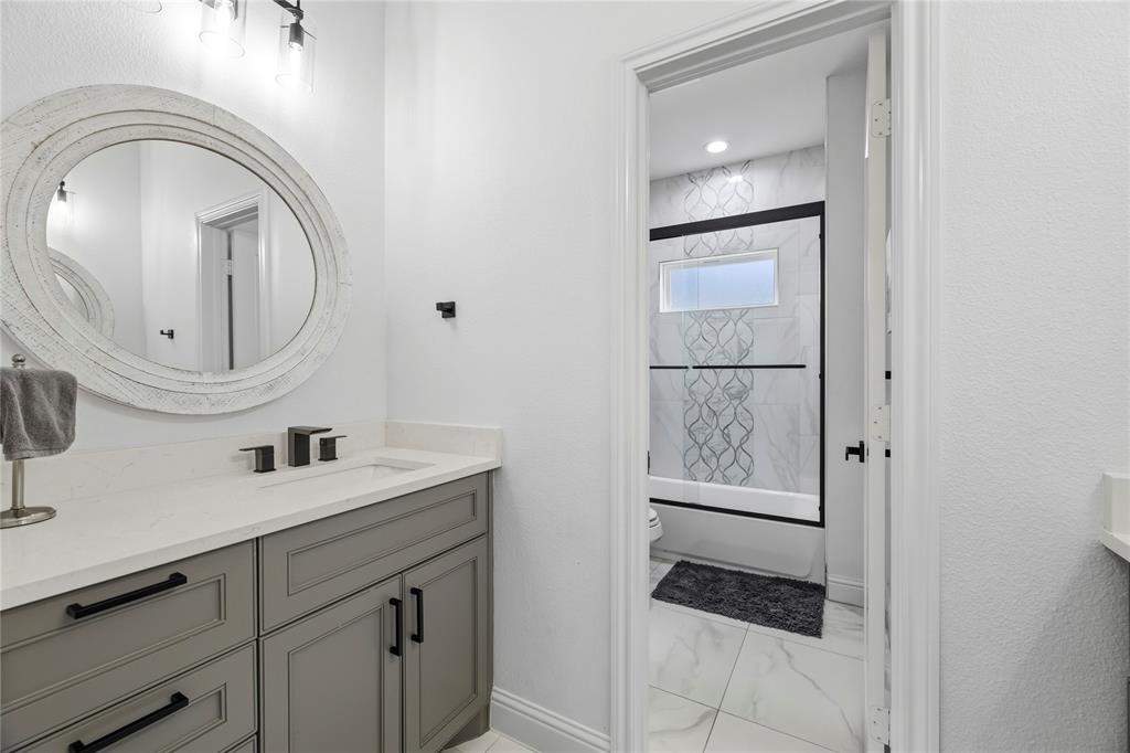 203 Colonial Drive Mabank, TX 75156 - Photo 28 of 36 a bathroom with a sink a toilet and a mirror