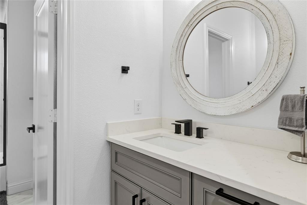 203 Colonial Drive Mabank, TX 75156 - Photo 29 of 36 a bathroom with a sink and a mirror