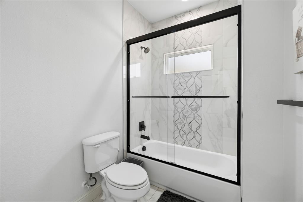203 Colonial Drive Mabank, TX 75156 - Photo 30 of 36 a white toilet sitting next to a shower