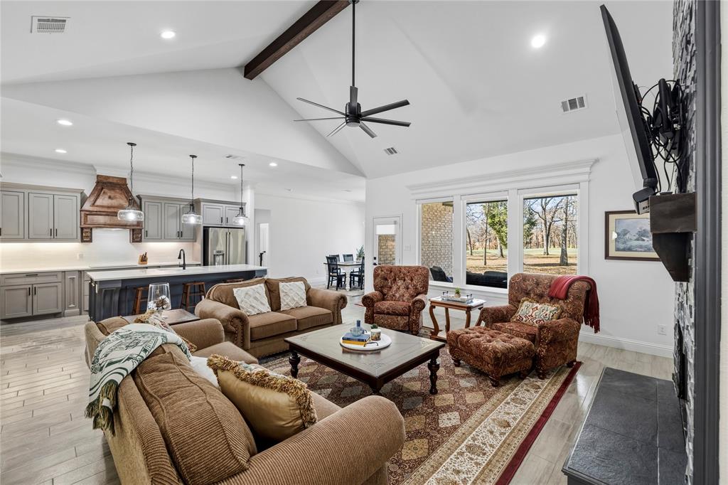 203 Colonial Drive Mabank, TX 75156 - Photo 5 of 36 a living room with furniture a fireplace and a flat screen tv