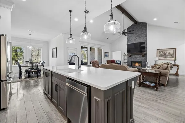 a large kitchen with a table and chairs