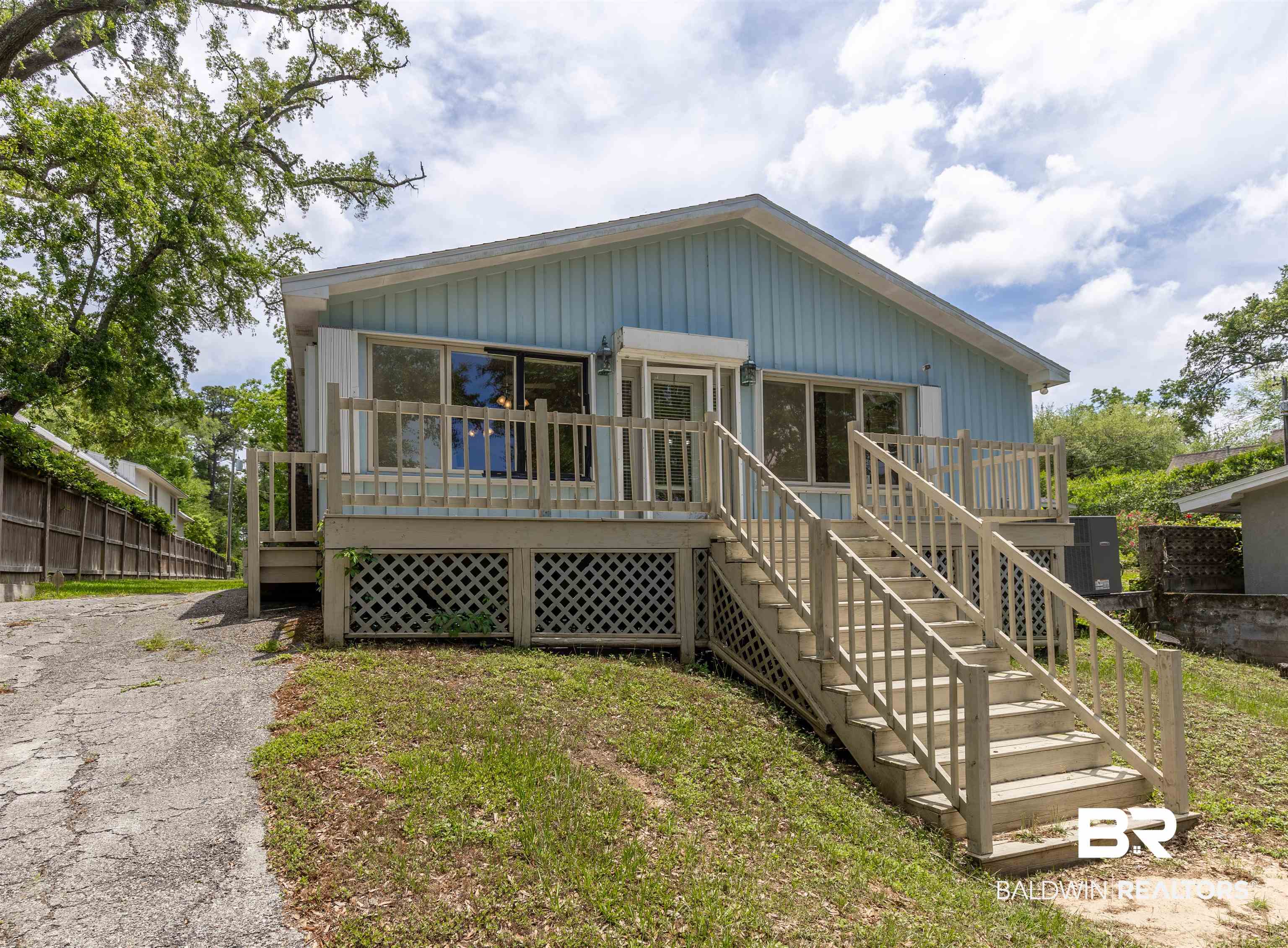 724 Mobile South Street Fairhope, AL 36532 - Photo 1 of 38 View of front of house with fence, stairs, and a deck