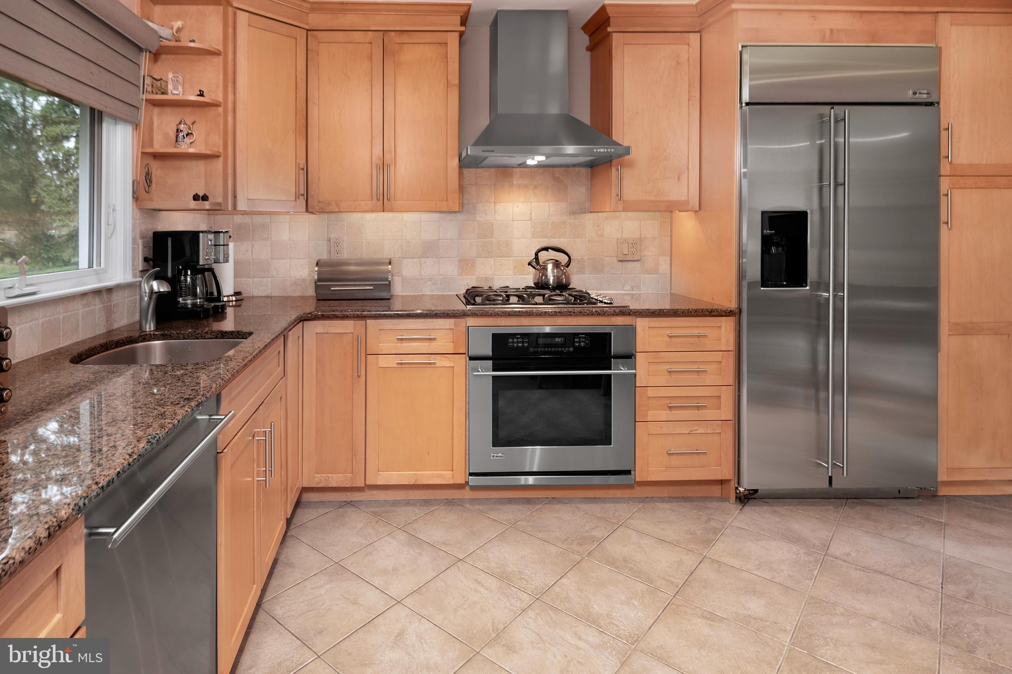 59 Wesleyan Drive Hamilton, NJ 08690 - Photo 12 of 25 a kitchen with stainless steel appliances granite countertop a stove a sink and a refrigerator