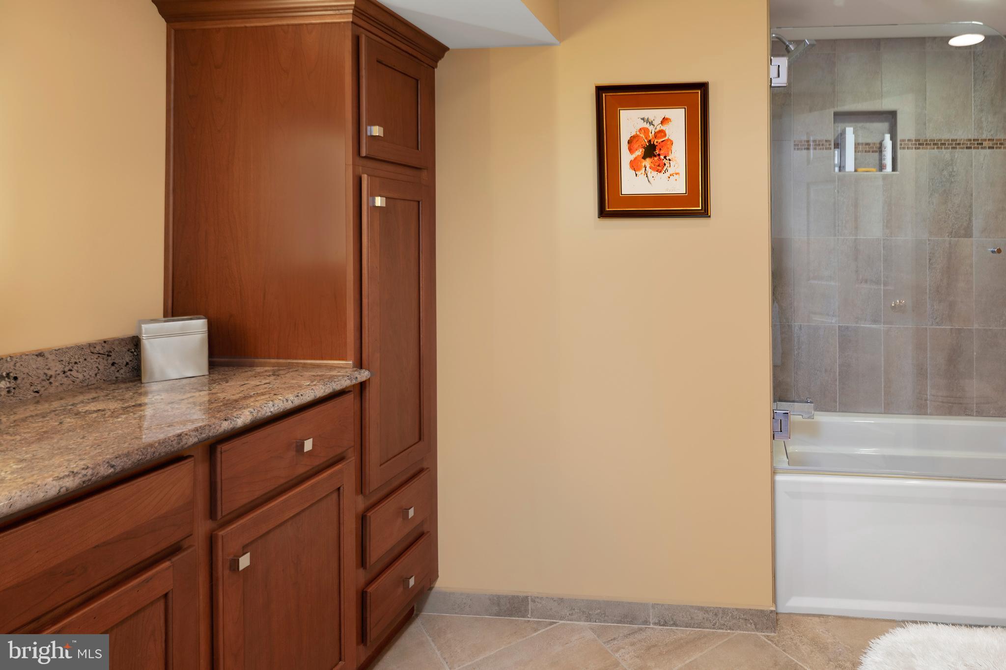 59 Wesleyan Drive Hamilton, NJ 08690 - Photo 16 of 25 a bathroom with a granite countertop sink a mirror a shower and a bathtub