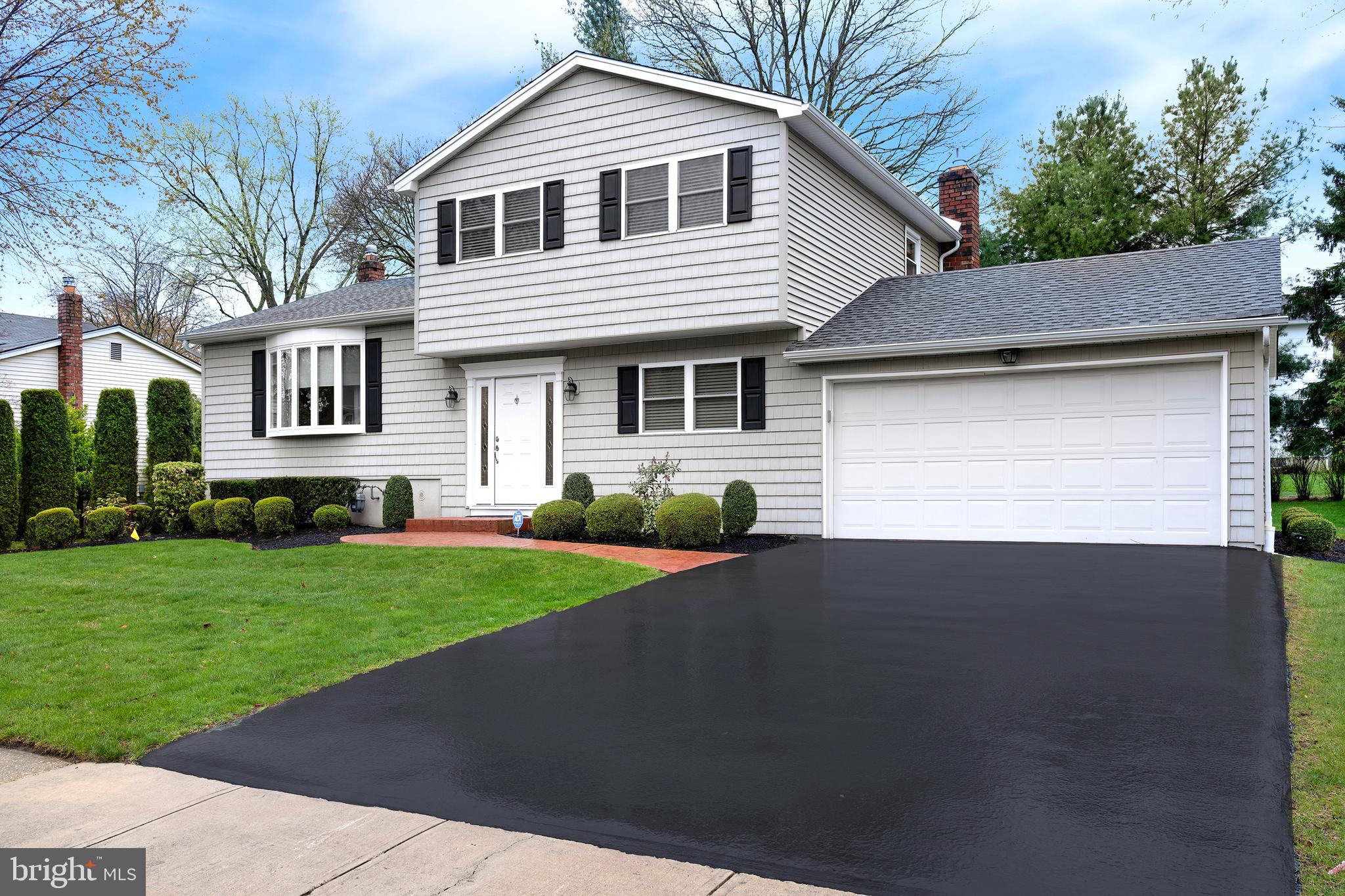 59 Wesleyan Drive Hamilton, NJ 08690 - Photo 2 of 25 a front view of a house with a yard and garage