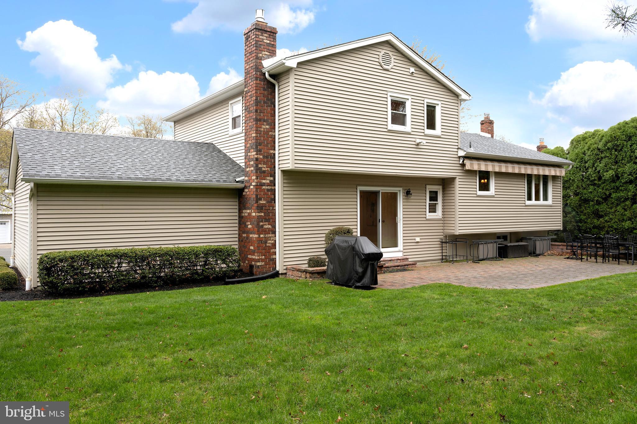 59 Wesleyan Drive Hamilton, NJ 08690 - Photo 22 of 25 a front view of a house with a garden and patio