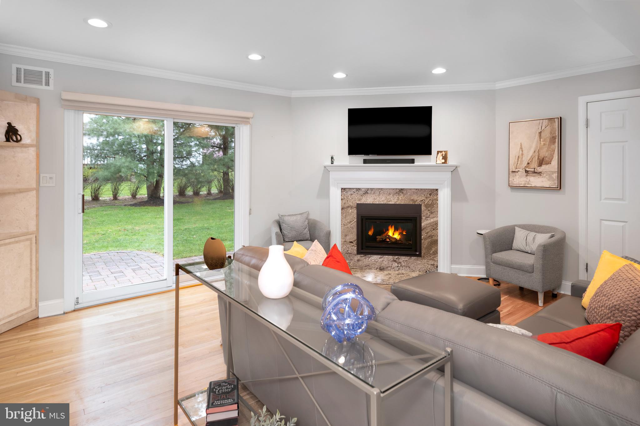 59 Wesleyan Drive Hamilton, NJ 08690 - Photo 5 of 25 a living room with furniture fireplace and a large window
