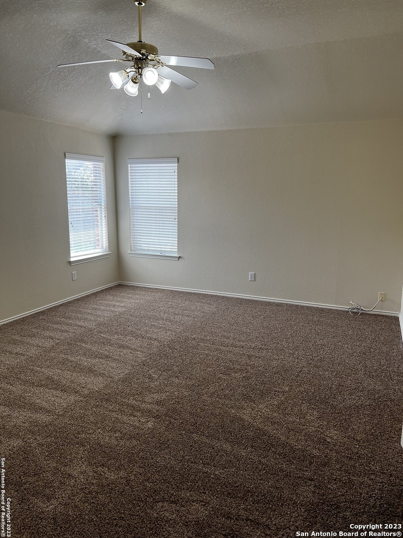 12610 Point Sound San Antonio, TX 78253 - Photo 27 of 39 en empty room with windows and fan