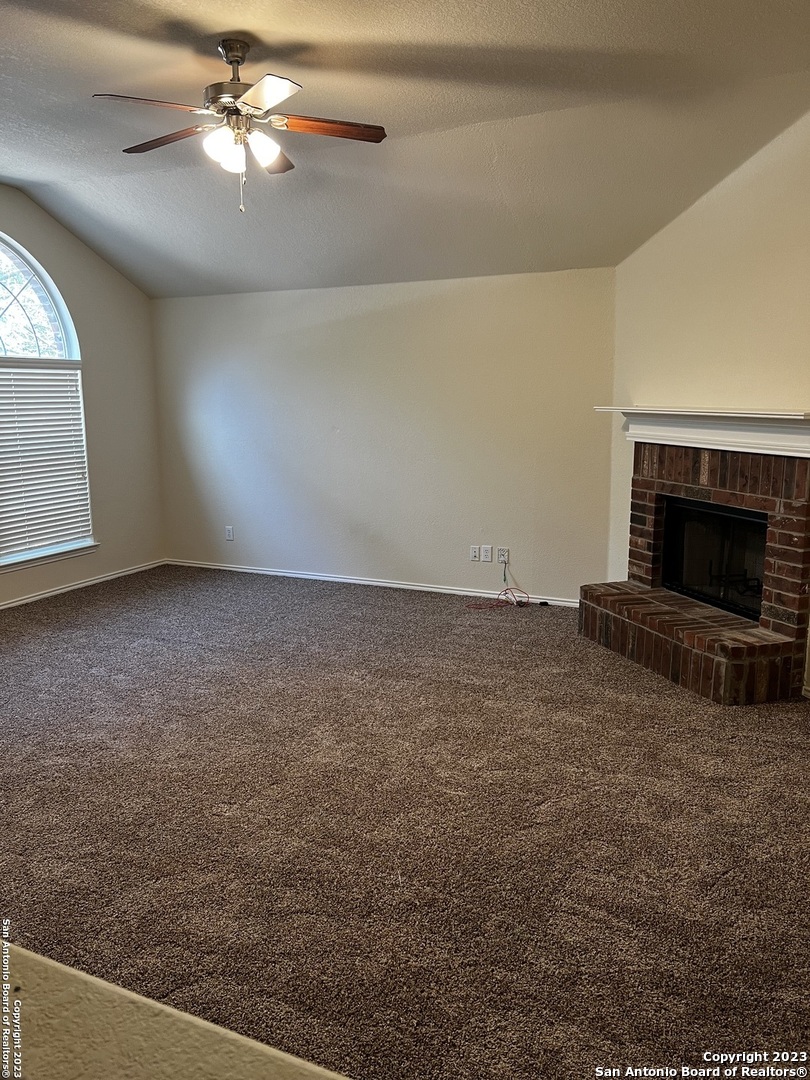 12610 Point Sound San Antonio, TX 78253 - Photo 5 of 39 en empty room with windows and fireplace