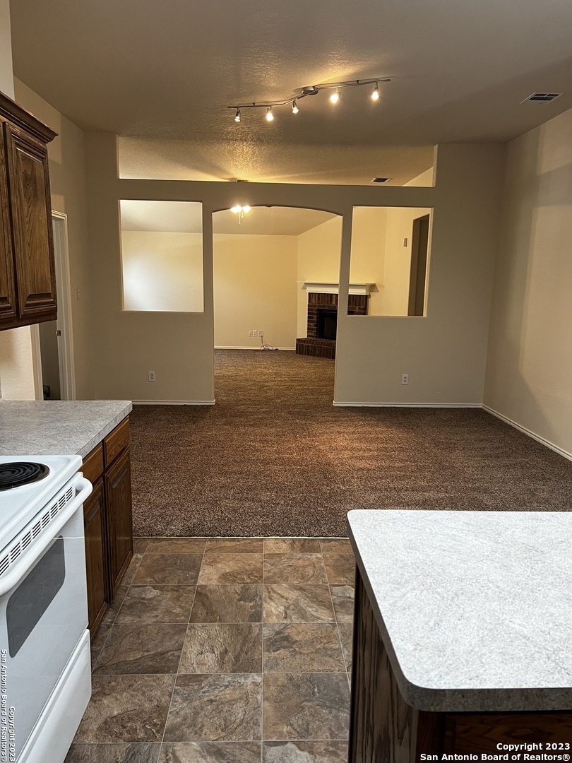 12610 Point Sound San Antonio, TX 78253 - Photo 9 of 39 a kitchen with kitchen island a counter top a stove and a sink