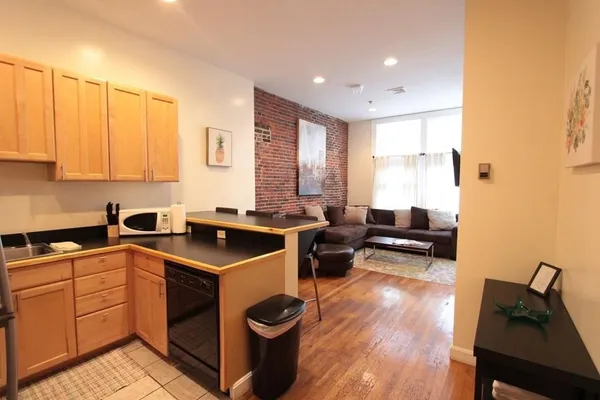 a kitchen with a stove sink and cabinets