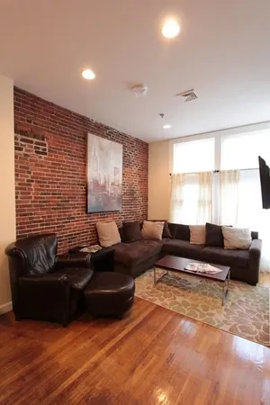 a living room with furniture window and a wooden floor