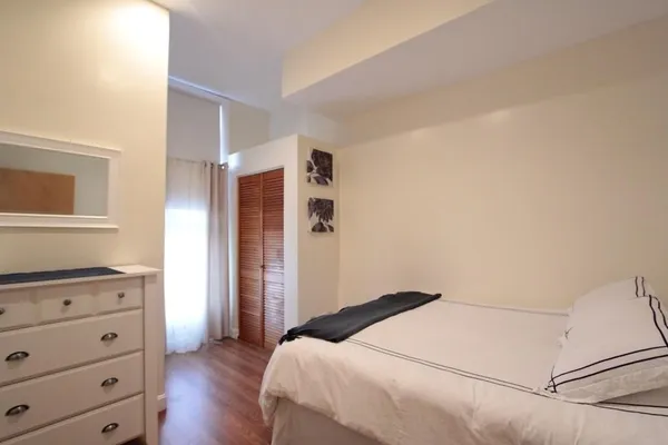 a bedroom with a bed and a dresser