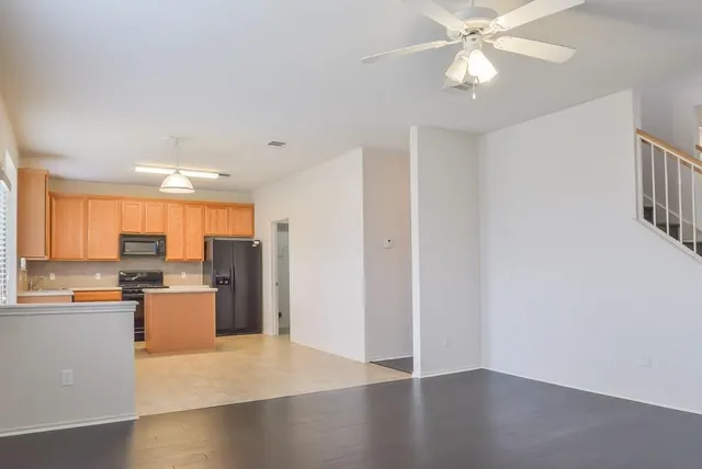a kitchen with stainless steel appliances granite countertop a refrigerator stove and sink