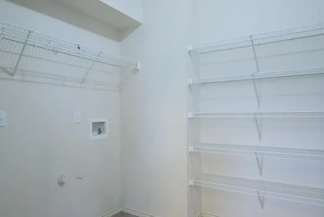 a view of a kitchen with a sink dishwasher a refrigerator and wooden floor