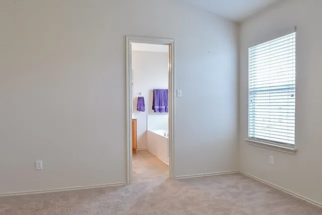 an empty room with a chandelier fan