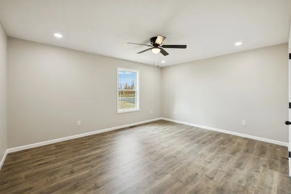 wooden floor in an empty room with a window