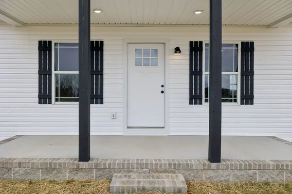 a view of empty room with wooden floor and ceiling fan