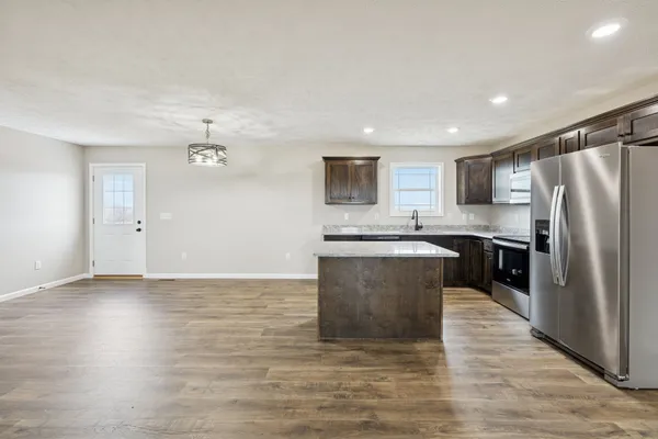 a kitchen with a stove a refrigerator and a sink