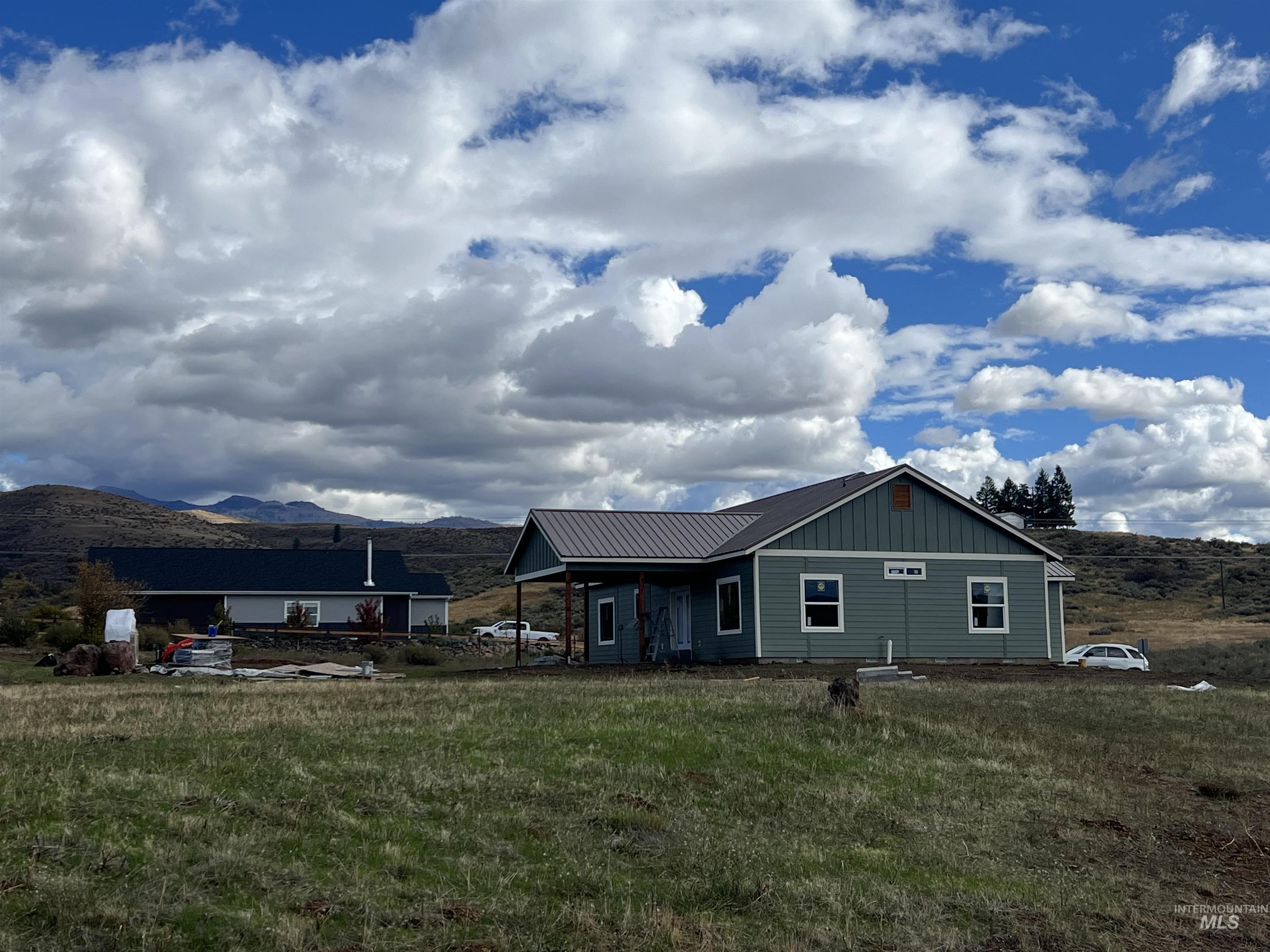 2300 Golf Council, ID 83612 - Photo 1 of 17 New construction home featuring light green siding and a dark metal roof