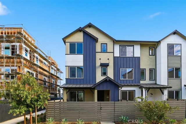 a front view of a residential apartment building with a yard