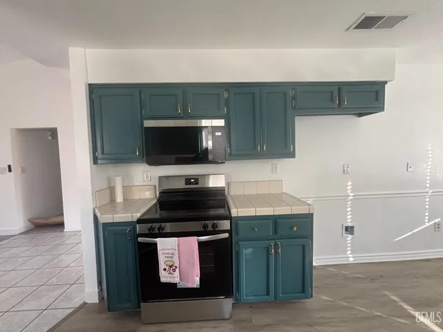 a kitchen with a sink and a stove top oven