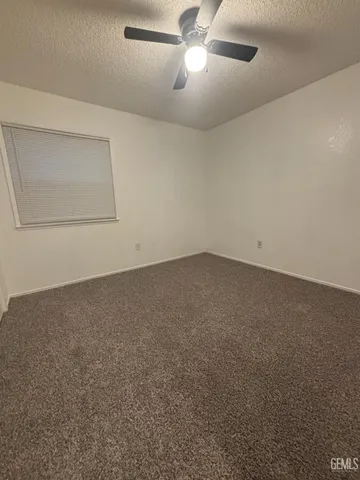 an empty room with a empty space and a ceiling fan