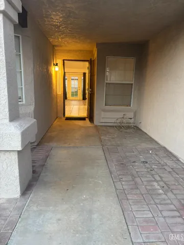 a view of an empty room with a fireplace and a window