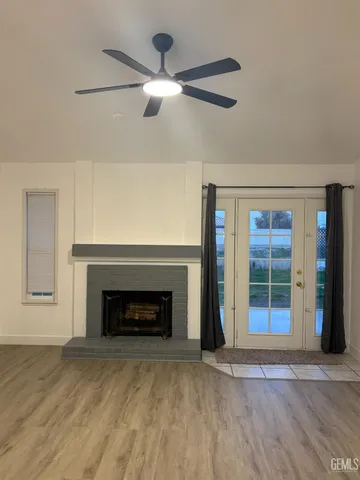 an empty room with fireplace and windows