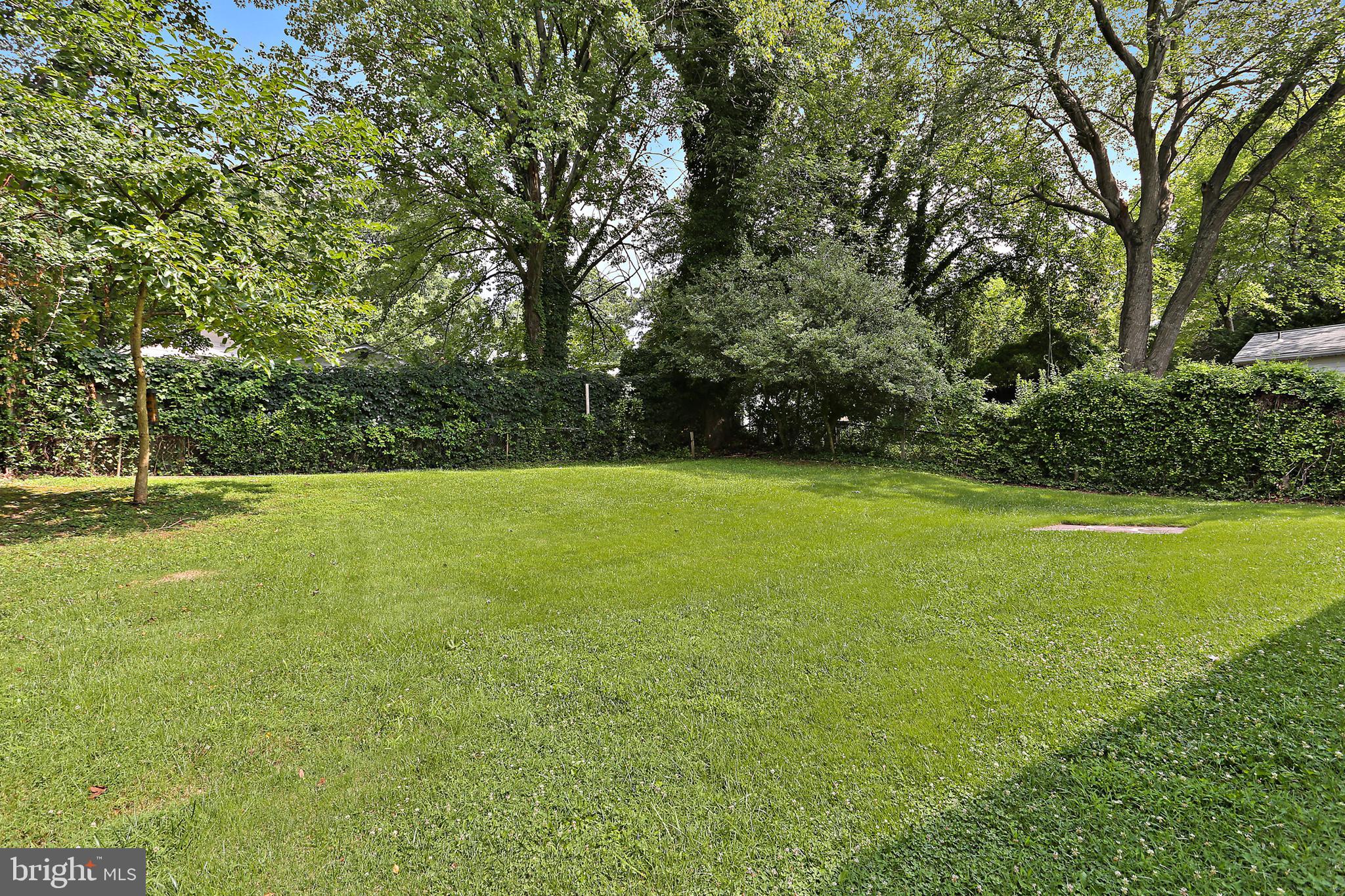 4113 Weller Road Silver Spring, MD 20906 - Photo 28 of 35 a view of a green field with wooden fence