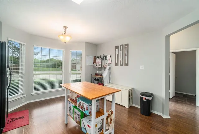 a room with pool table and wooden floor
