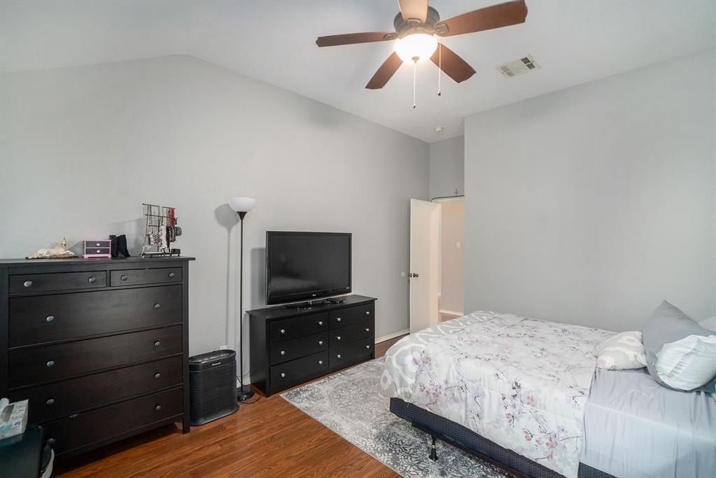 2808 Wakecrest Drive Fort Worth, TX 76108 - Photo 14 of 22 a bedroom with a bed and a flat screen tv