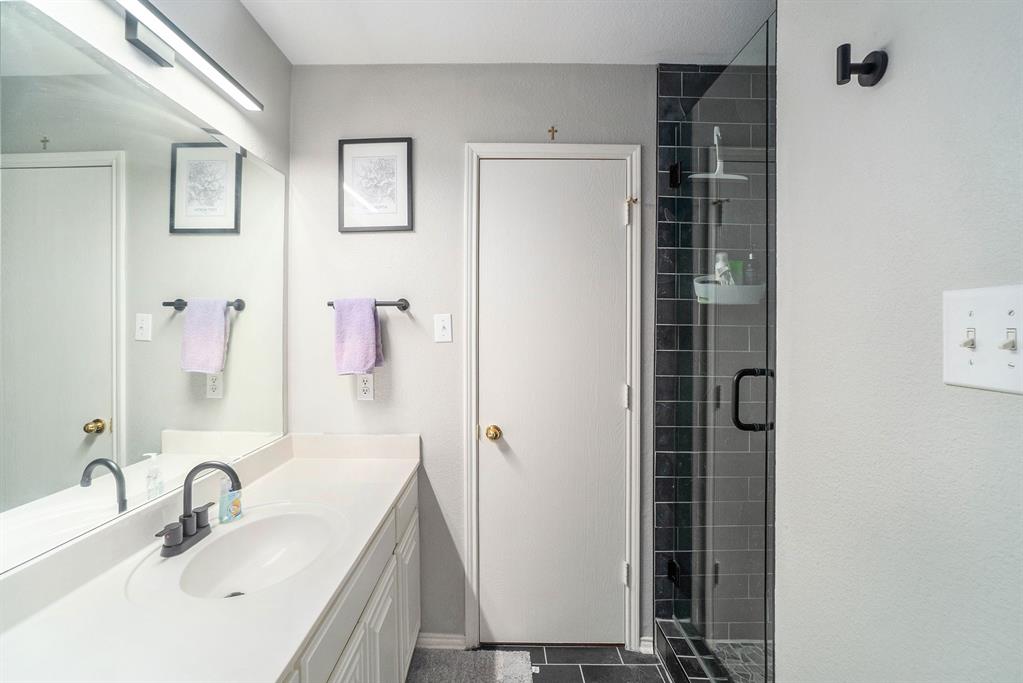 2808 Wakecrest Drive Fort Worth, TX 76108 - Photo 16 of 22 a bathroom with a sink and a large mirror