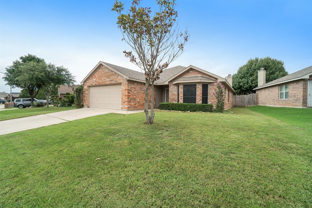 2808 Wakecrest Drive Fort Worth, TX 76108 - Photo 2 of 22 a front view of a house with a garden and trees