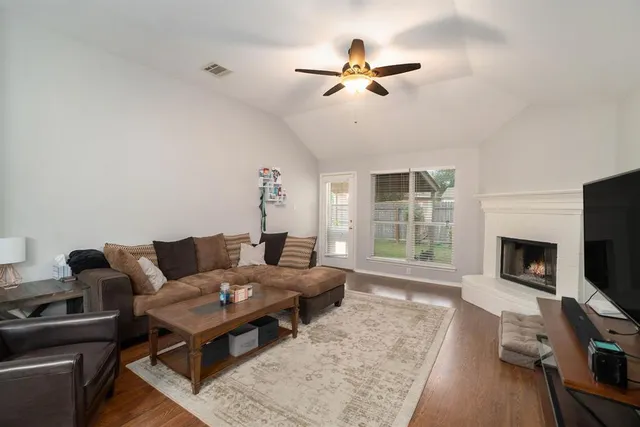 a living room with furniture a fireplace and a flat screen tv