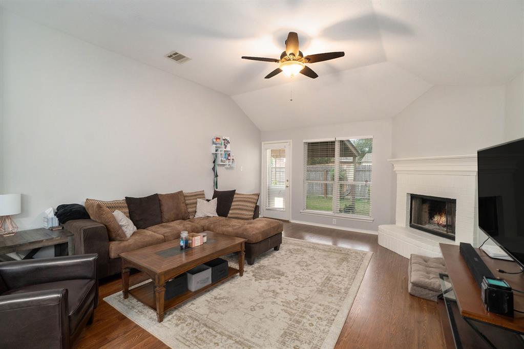 2808 Wakecrest Drive Fort Worth, TX 76108 - Photo 4 of 22 a living room with furniture a fireplace and a flat screen tv