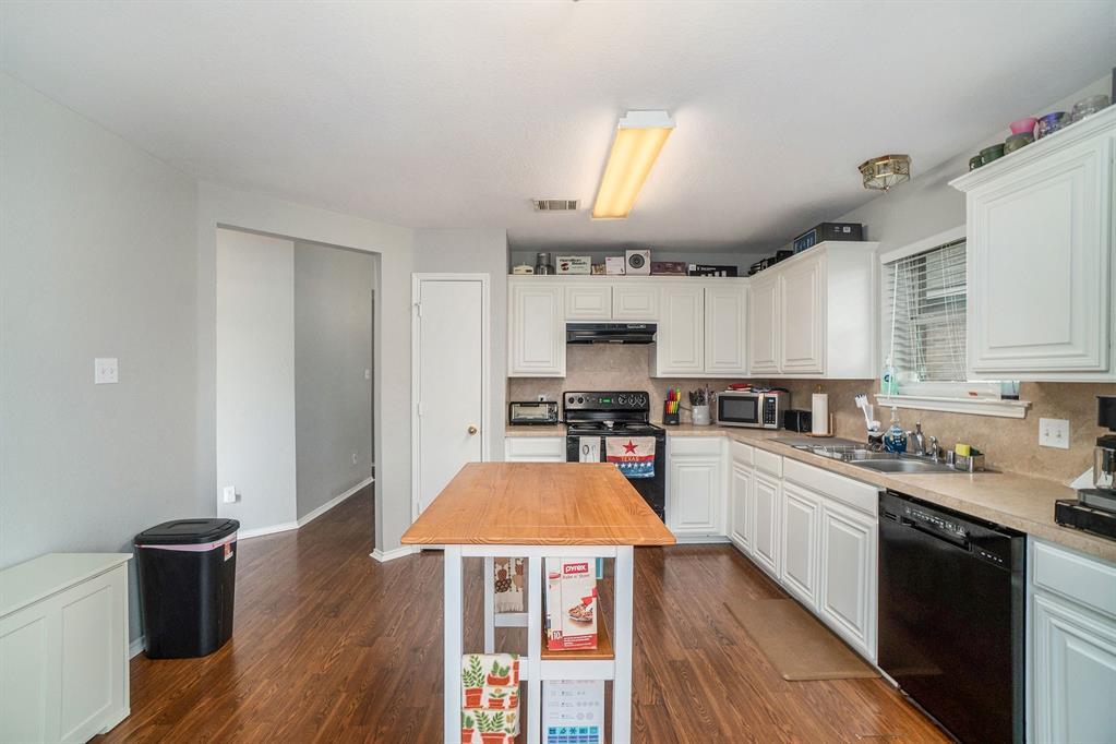 2808 Wakecrest Drive Fort Worth, TX 76108 - Photo 8 of 22 a kitchen with stainless steel appliances a stove sink refrigerator and cabinets