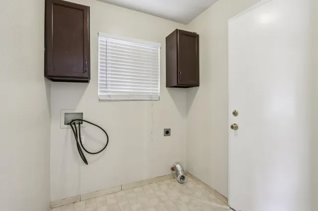an outdoor sitting area with couch and a potted plant
