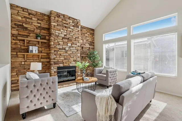 a kitchen with stainless steel appliances granite countertop a sink a stove and a refrigerator