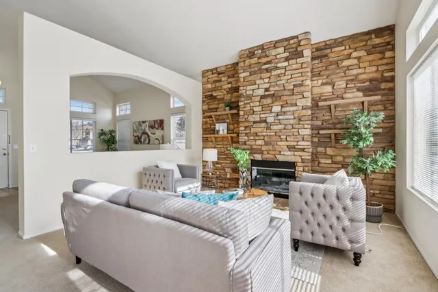 a kitchen with a stove a sink cabinetry and a potted plant