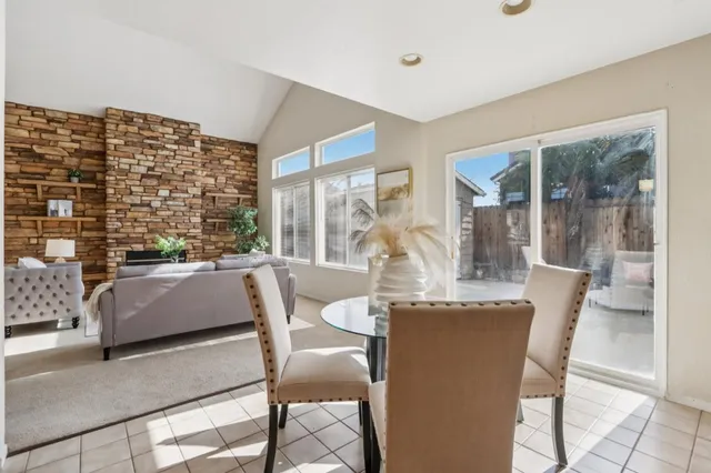 a living room with furniture a fireplace and a window