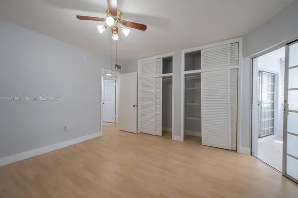 a view of an empty room with a ceiling fan