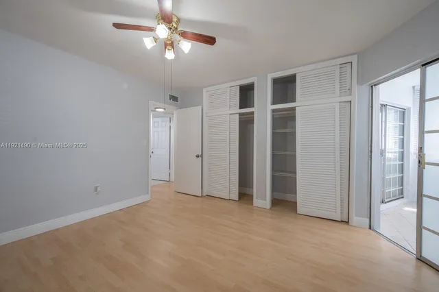 a view of an empty room with a ceiling fan