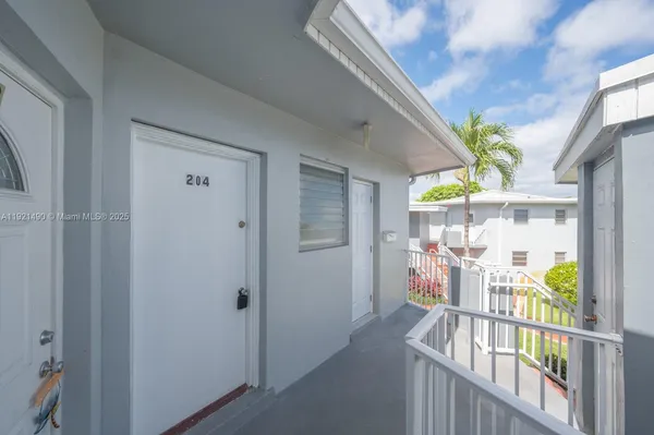 a view of a porch with dining table and chairs