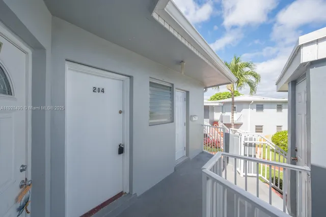 a view of a porch with dining table and chairs