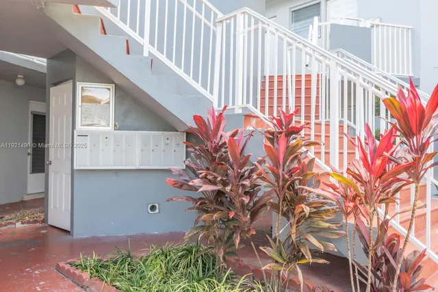 a view of entryway with flower plants