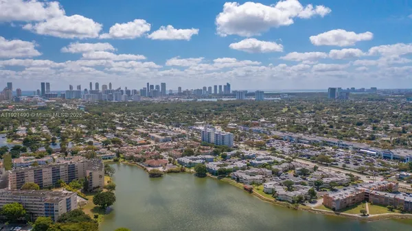 an aerial view of a city with a lake view