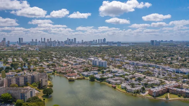 an aerial view of a city with a lake view