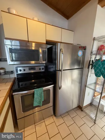 a bedroom with a bed and a mirror